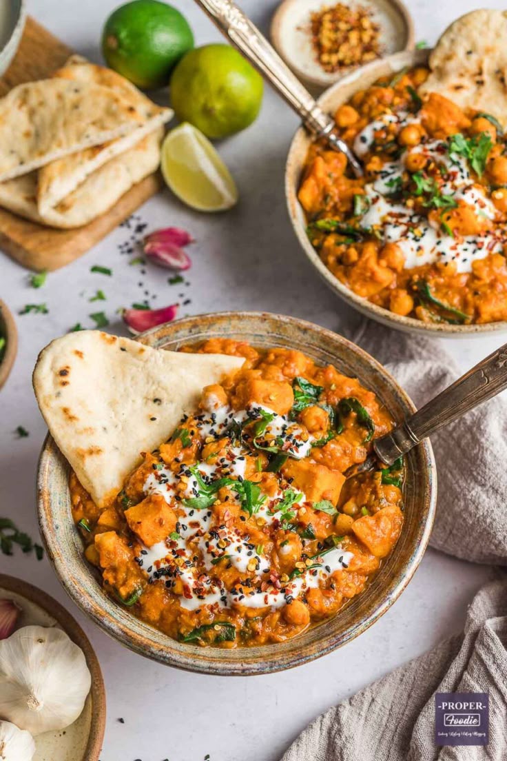 Sweet potato and spinach curry in a bowl with naan bread